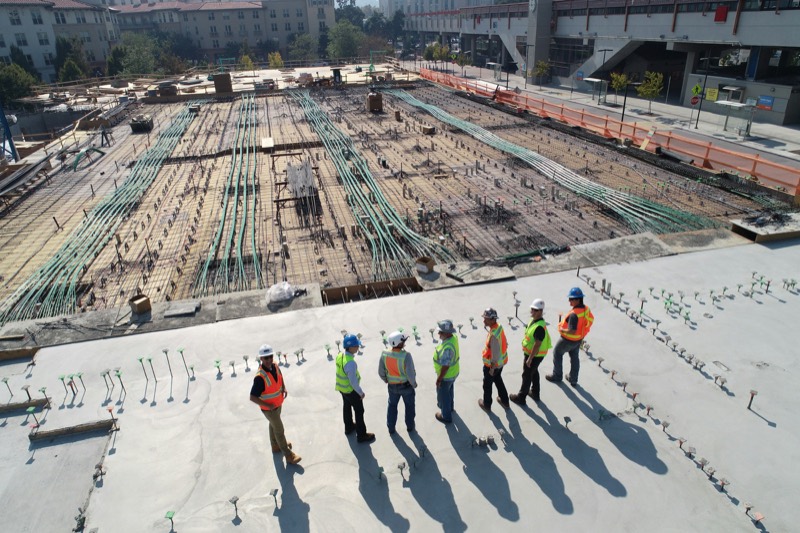Commercial construction site with crews reviewing the foundation works