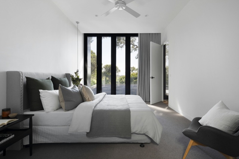 Serene bedroom suite with garden-facing glass doors