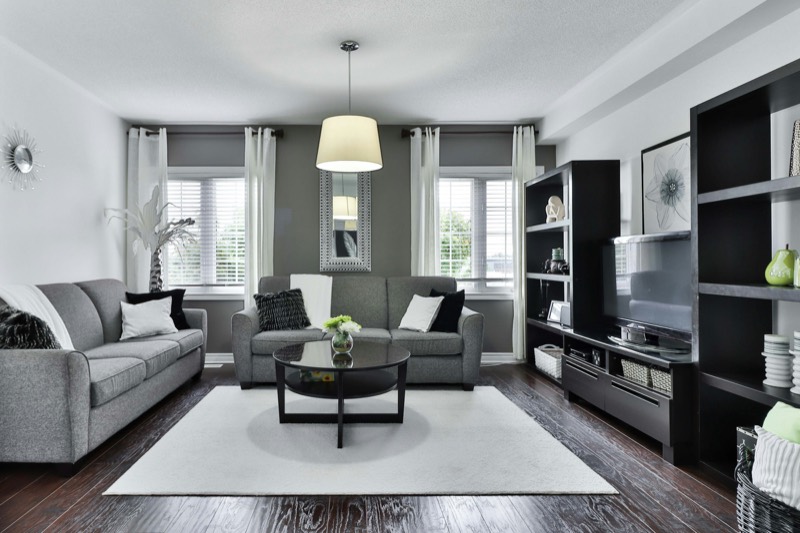Staged family living room in soft grays prepared for sale